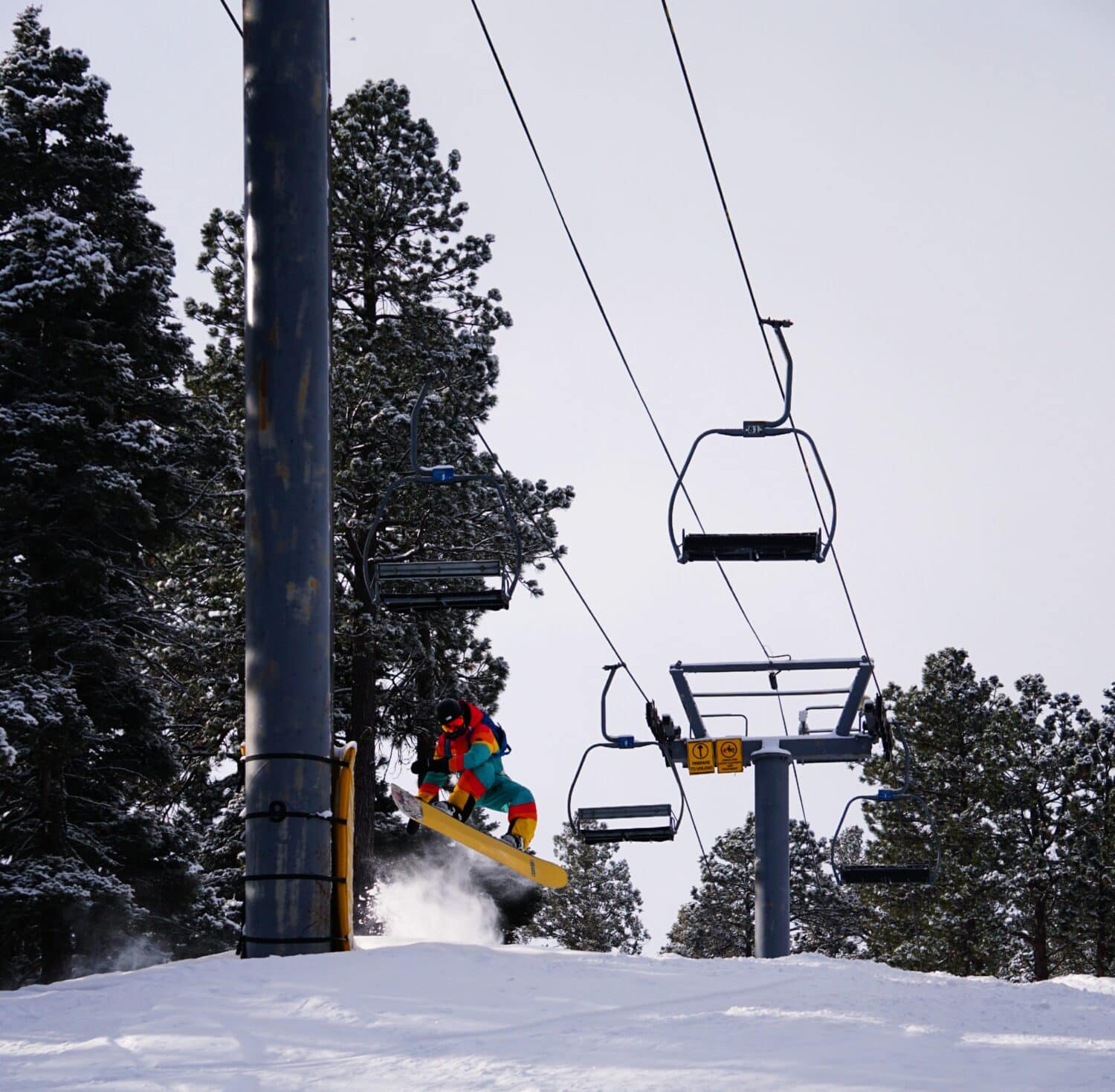 Snowboarder hitting jump at Sipapu