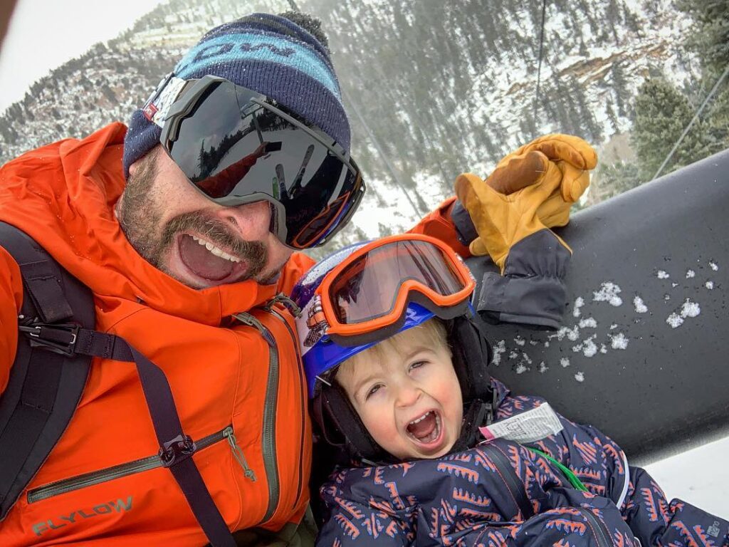 dad and son on lift enjoying season pass payment plan